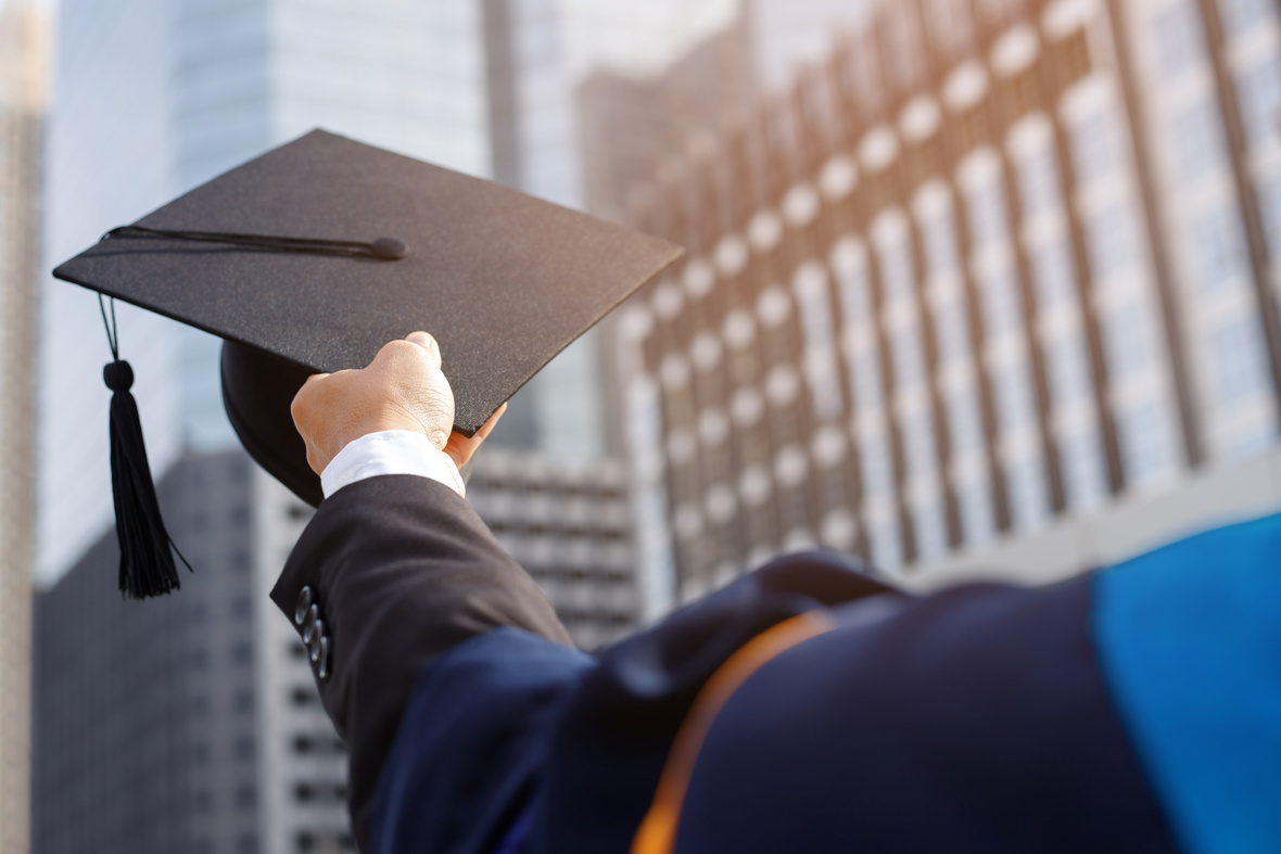 Graduate Holding a Mortarboard  